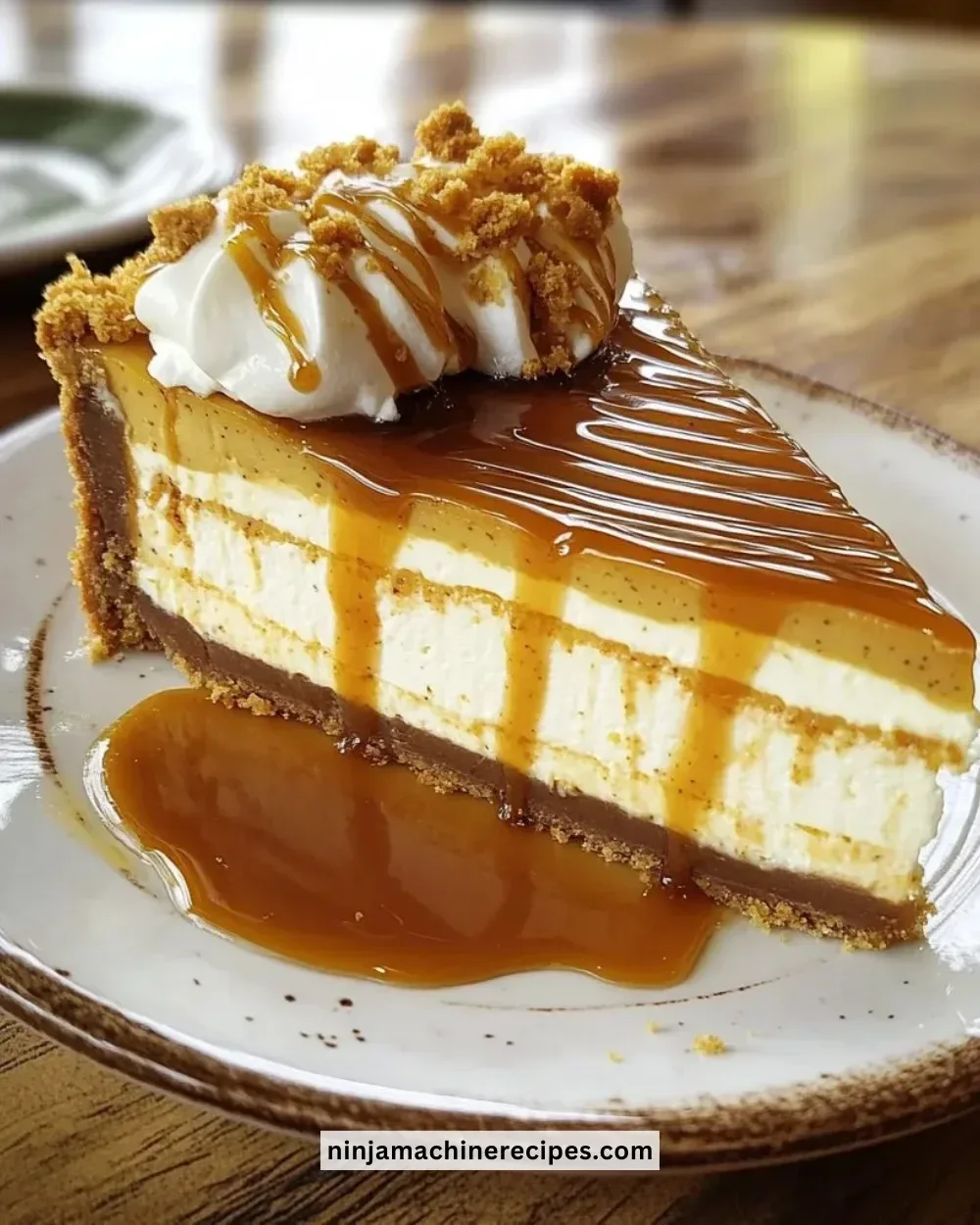Slice of Olive Garden Pumpkin Cheesecake with whipped cream and pumpkin garnish