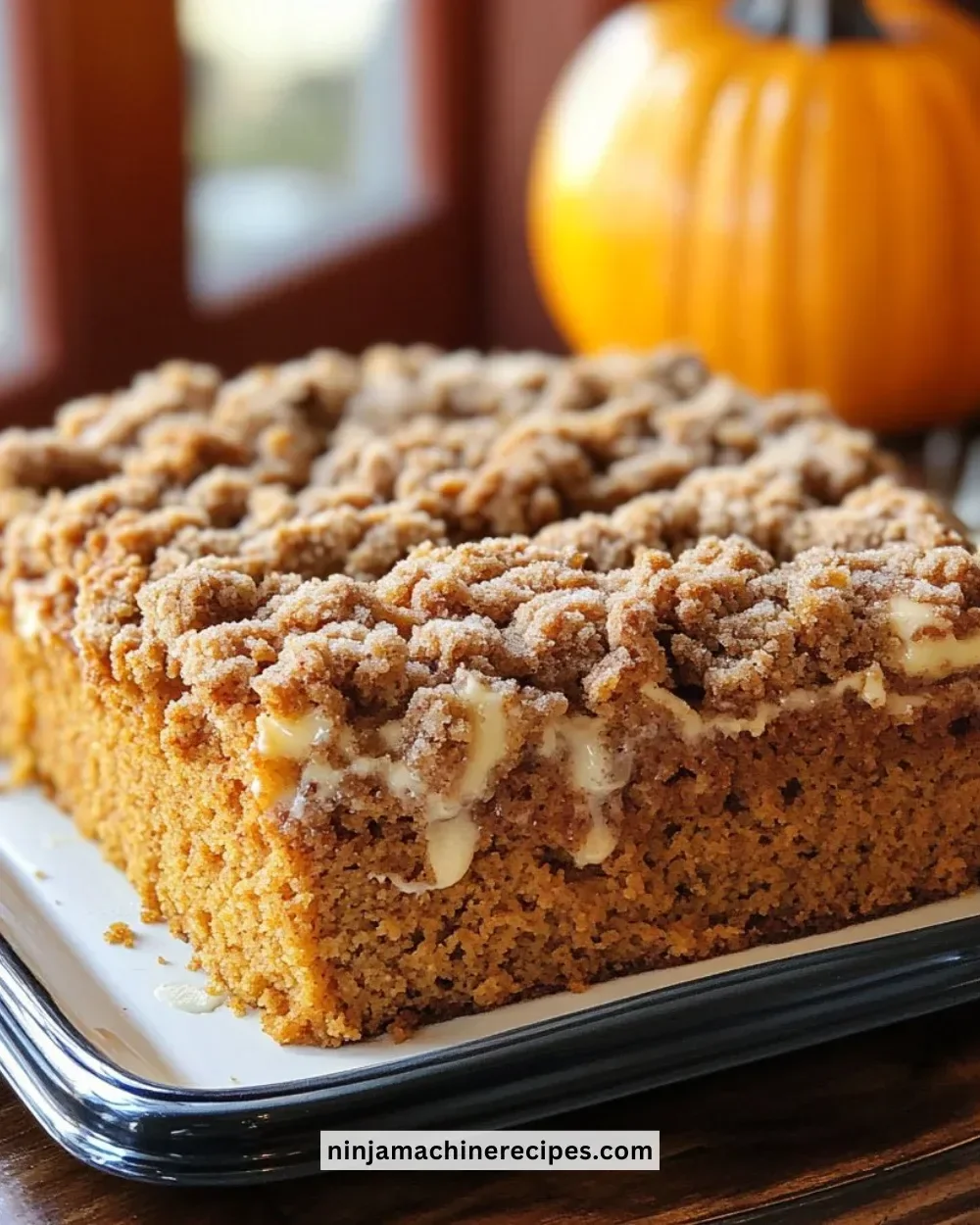 Deliciously spiced Pumpkin Coffee Cake served on a rustic plate