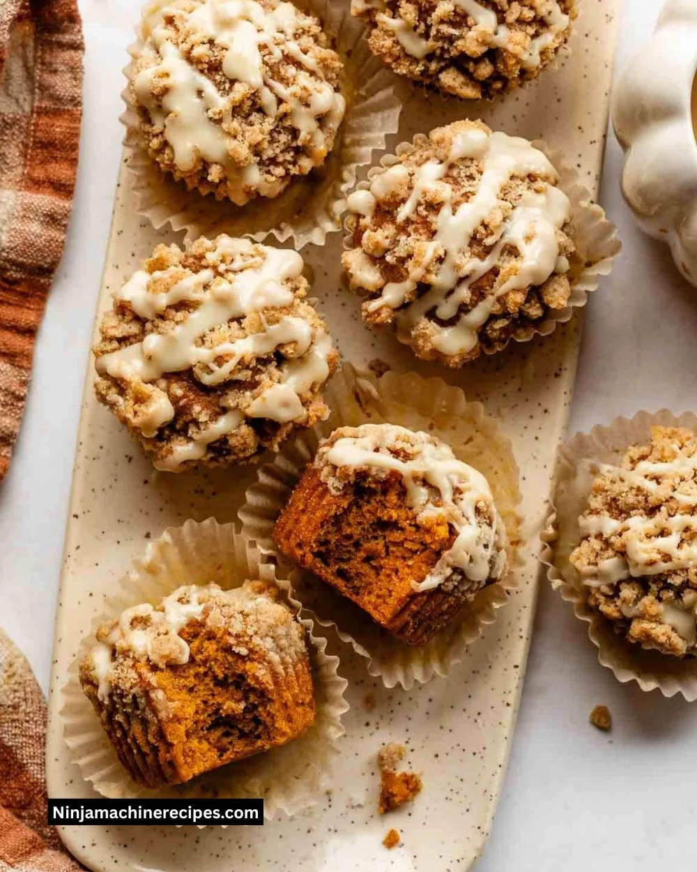 Delicious Pumpkin Crumb Cake Muffins topped with a buttery crumb topping