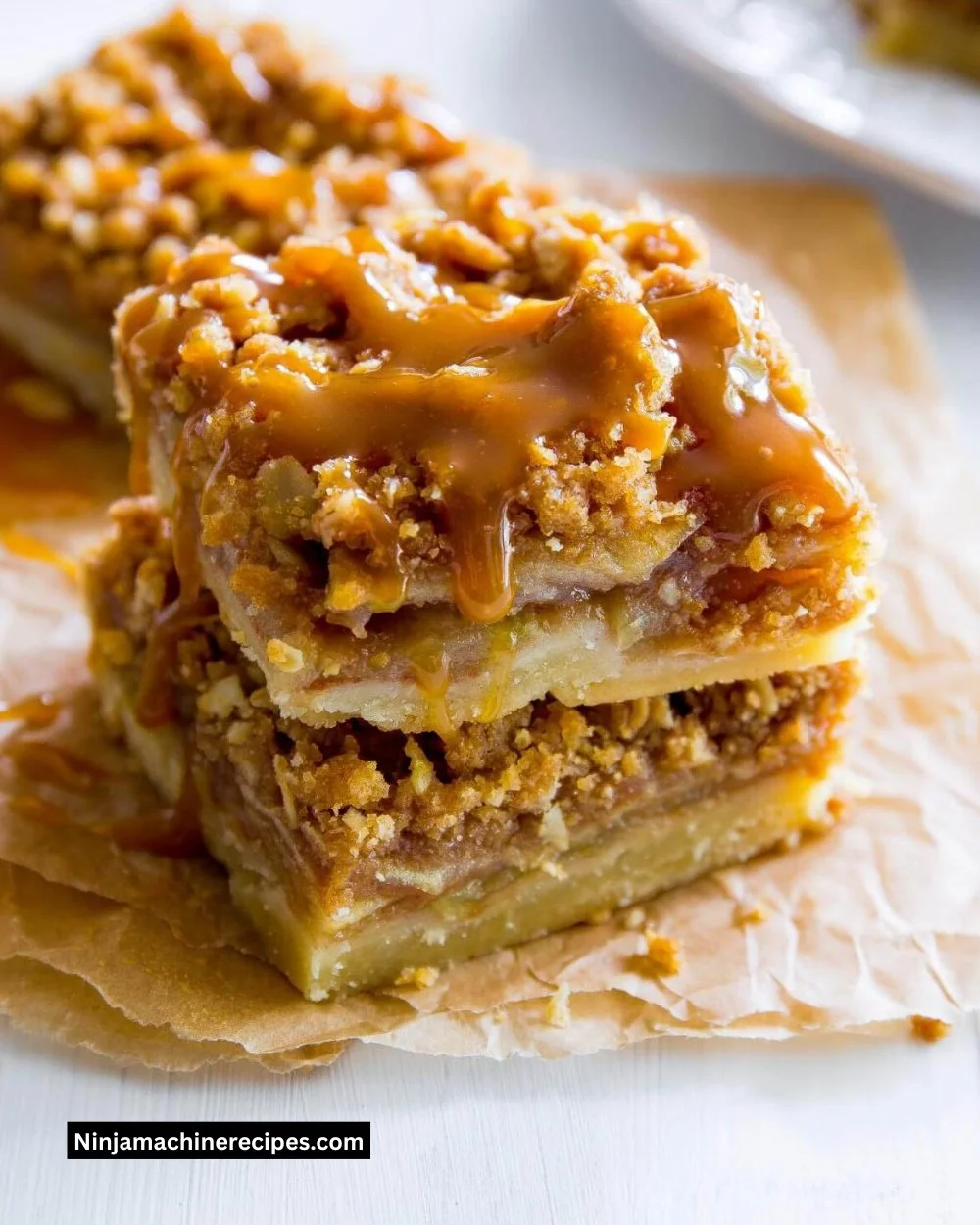 Delicious salted caramel apple pie bars showcasing caramel and apples.