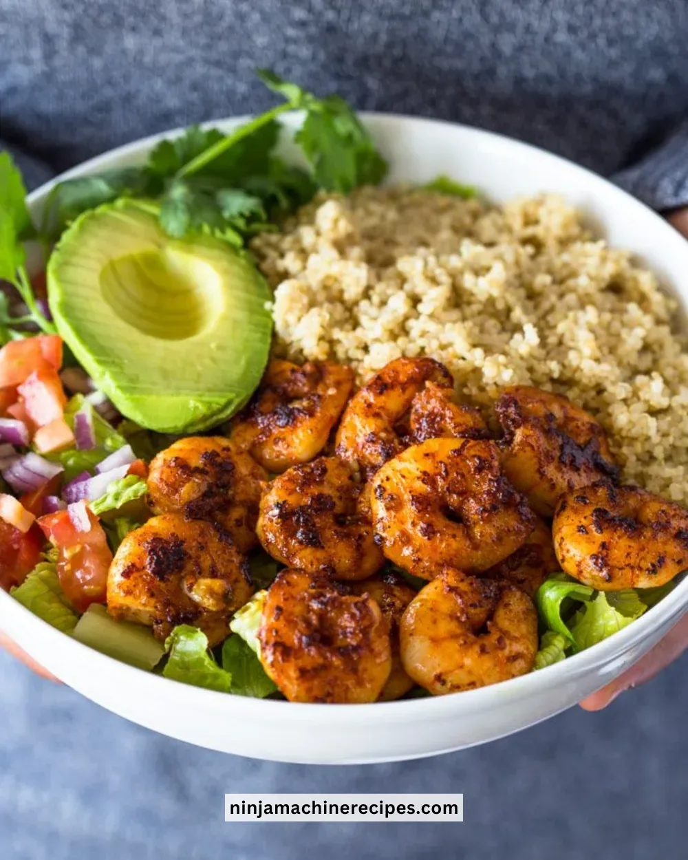 Delicious shrimp avocado quinoa bowls garnished with fresh herbs
