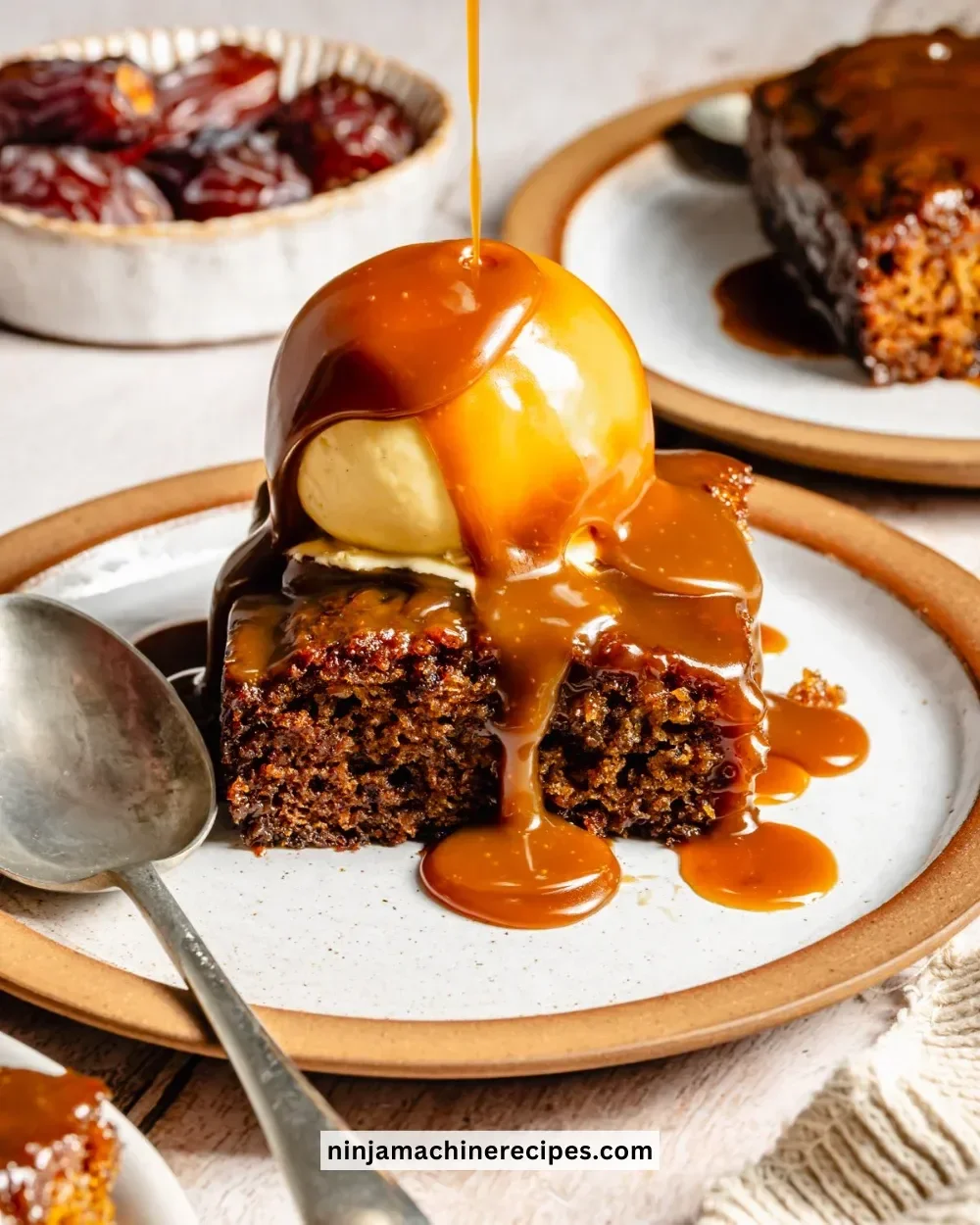 Delicious sticky date cake with caramel sauce and whipped cream