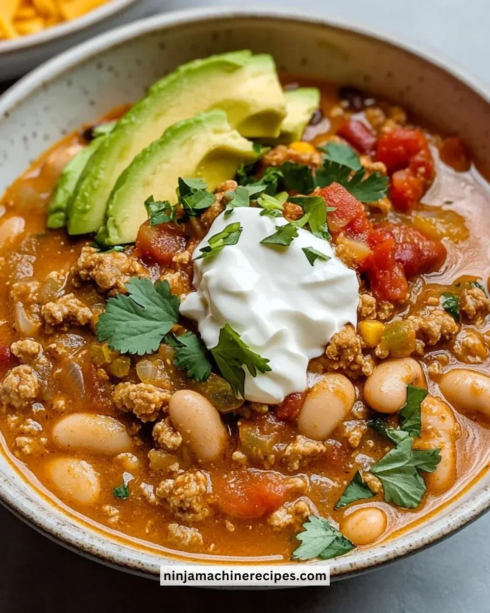 Bowl of Turkey White Bean Chili garnished with cilantro and lime