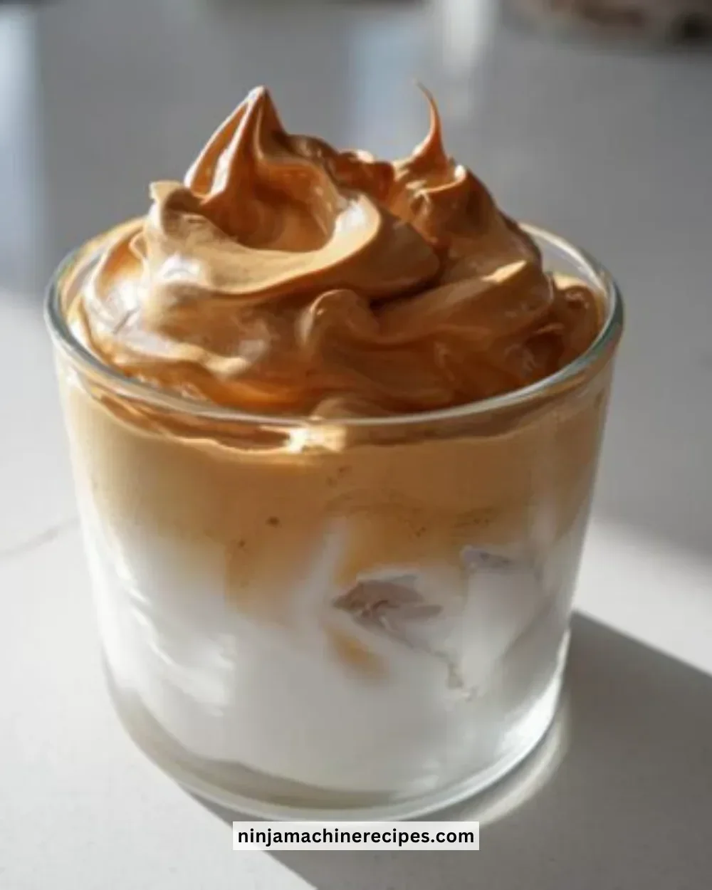 Delicious Dalgona whipped coffee topped with creamy foam in a glass