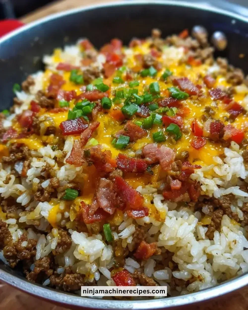 Bacon cheeseburger rice skillet topped with cheese and crispy bacon.