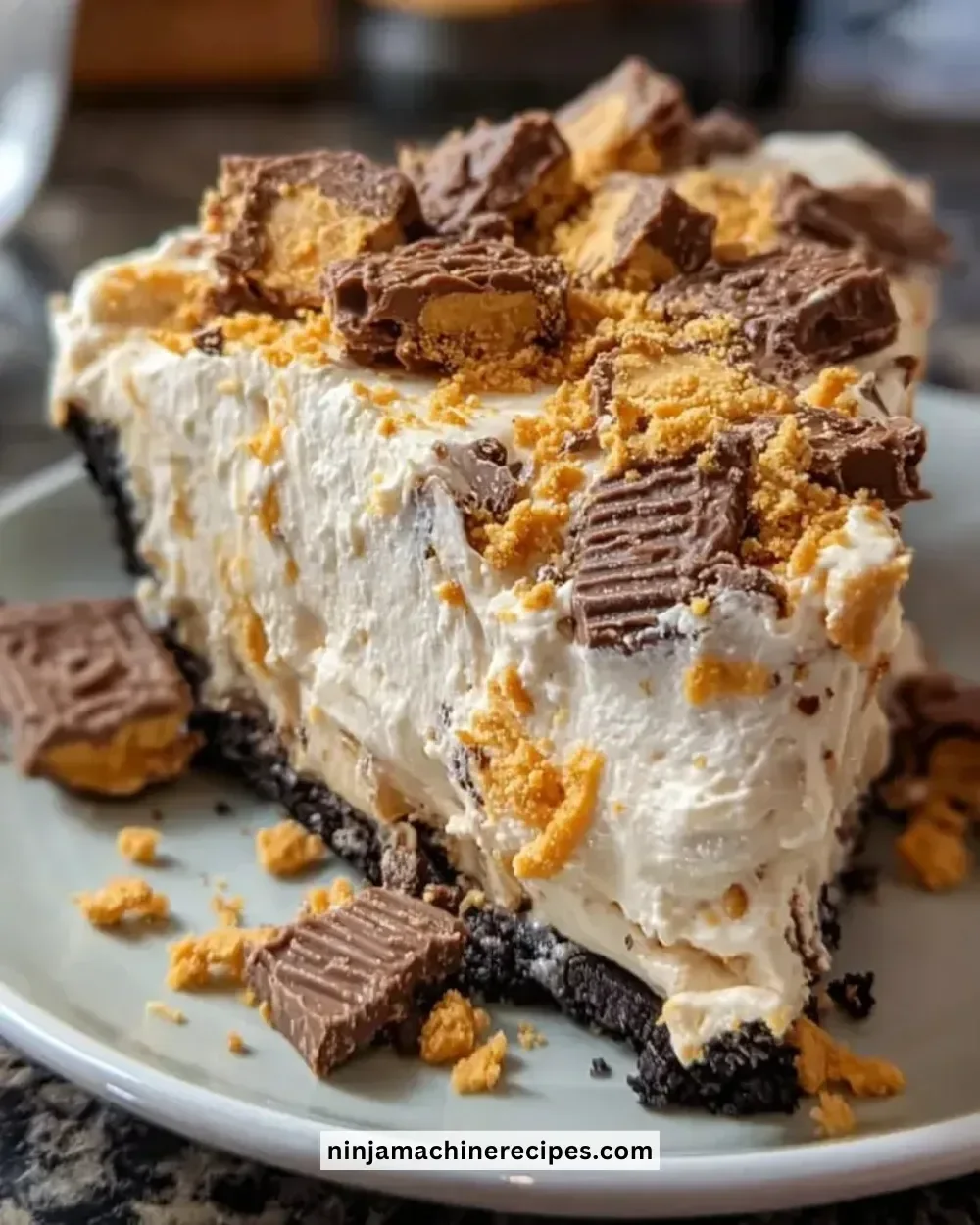 Slice of creamy Butterfinger Peanut Butter Pie topped with crushed Butterfinger candy