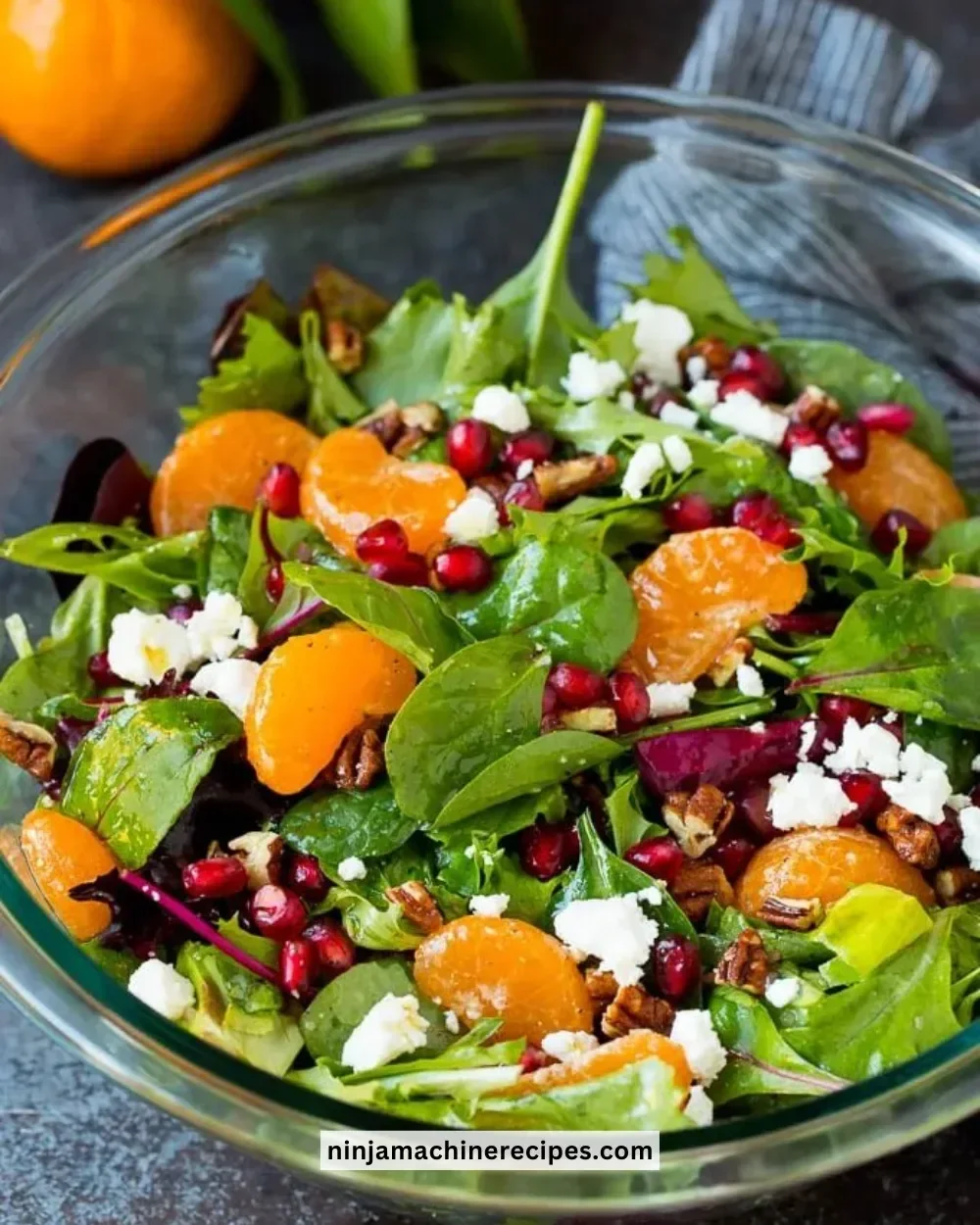 A vibrant Christmas salad featuring fresh greens, pomegranate, and festive toppings.