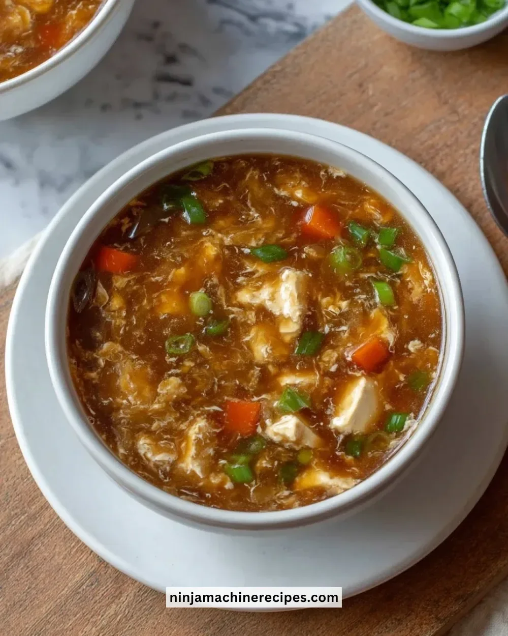 Bowl of classic hot and sour soup with tofu and mushrooms