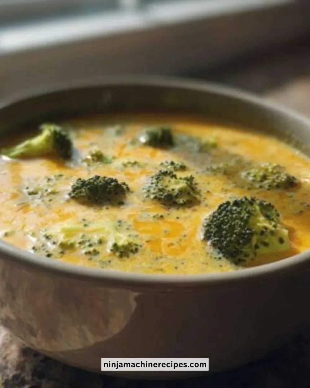 Bowl of creamy copycat Panera broccoli cheddar soup topped with cheese and croutons
