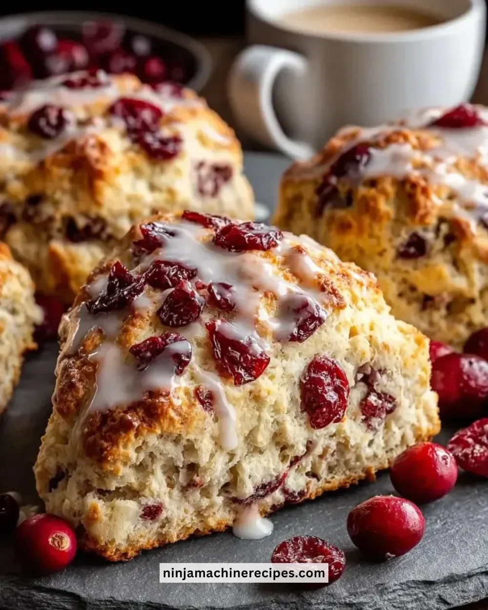 Freshly baked Cranberry Orange Maple Scones on a rustic wooden table