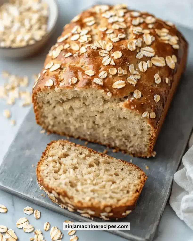 Loaf of Greek yogurt oat bread on a wooden cutting board
