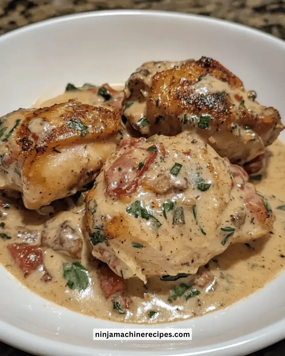 Creamy Tuscan chicken thighs cooked in a crockpot, ready to serve.