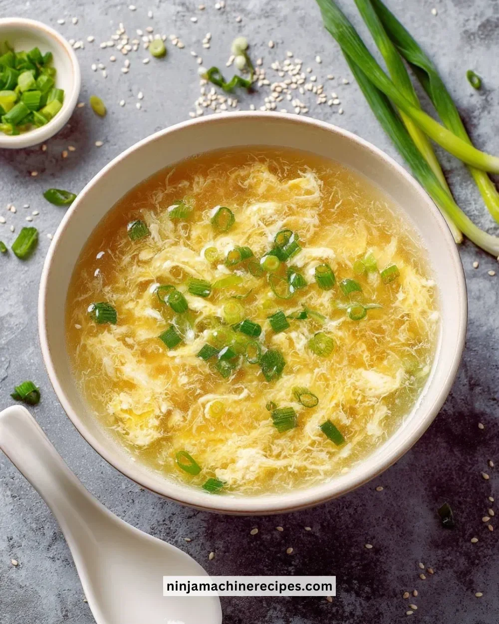 Bowl of easy homemade egg drop soup garnished with green onions