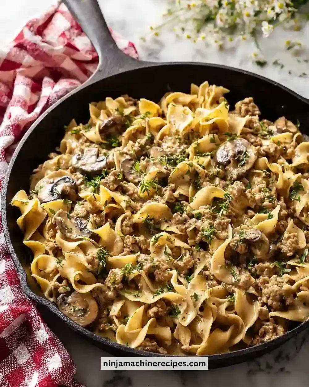 Delicious Easy Ground Turkey Stroganoff served in a bowl with pasta and herbs