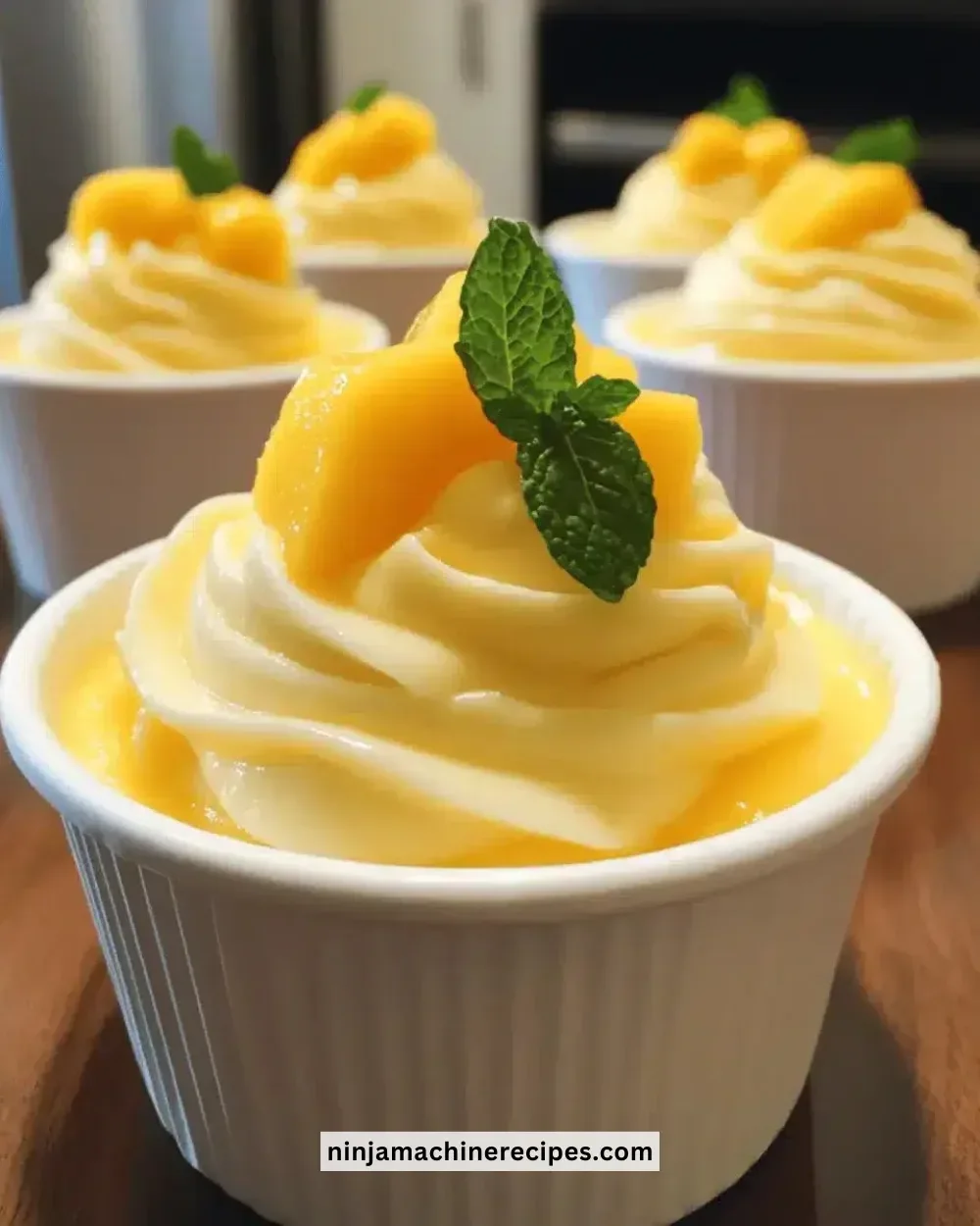 Delicious easy instant mango cream cups dessert served in glass containers