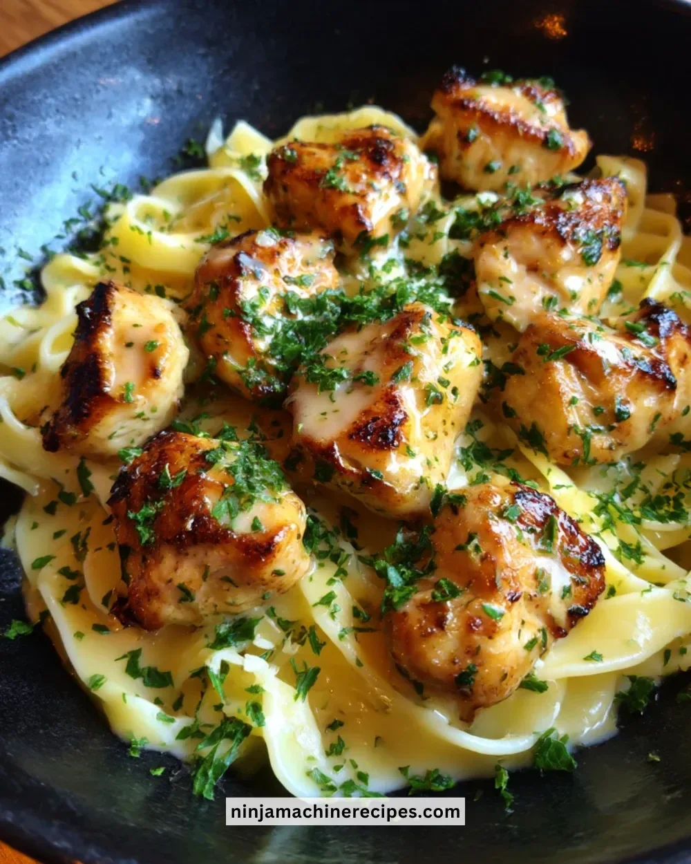 Garlic Butter Chicken Bites served with creamy Parmesan pasta in a bowl