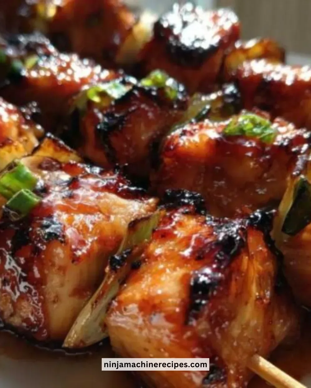 Grilled Honey Sriracha Chicken Skewers on a platter with fresh herbs