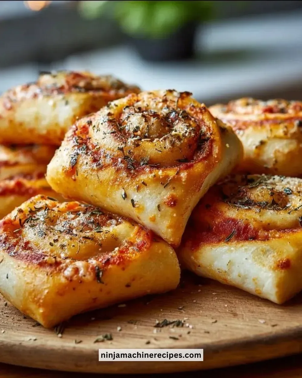 Delicious homemade pizza rolls served on a wooden platter with dipping sauce.