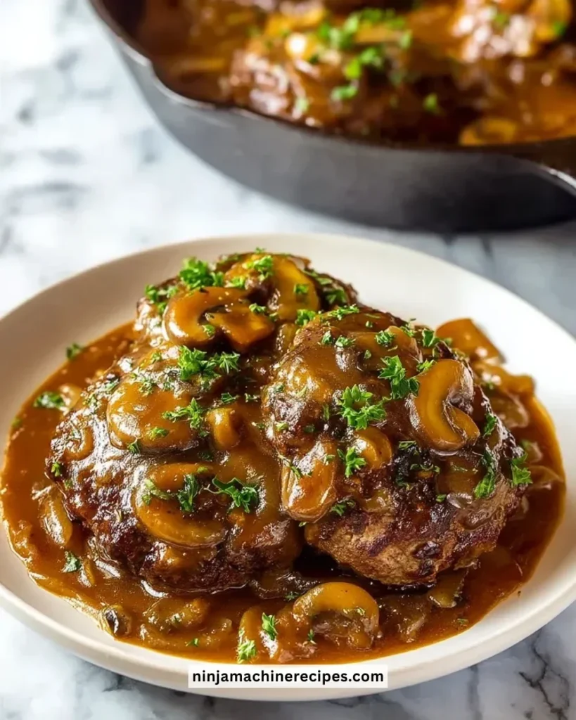 Delicious homemade Salisbury steak served with gravy and mashed potatoes.