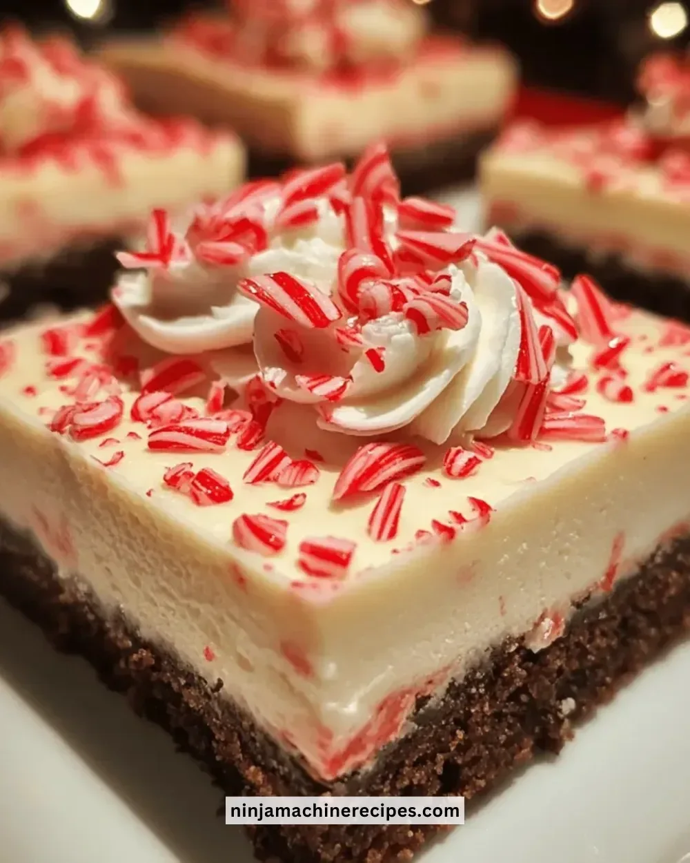 Irresistible Christmas peppermint cheesecake bars topped with holiday decorations.