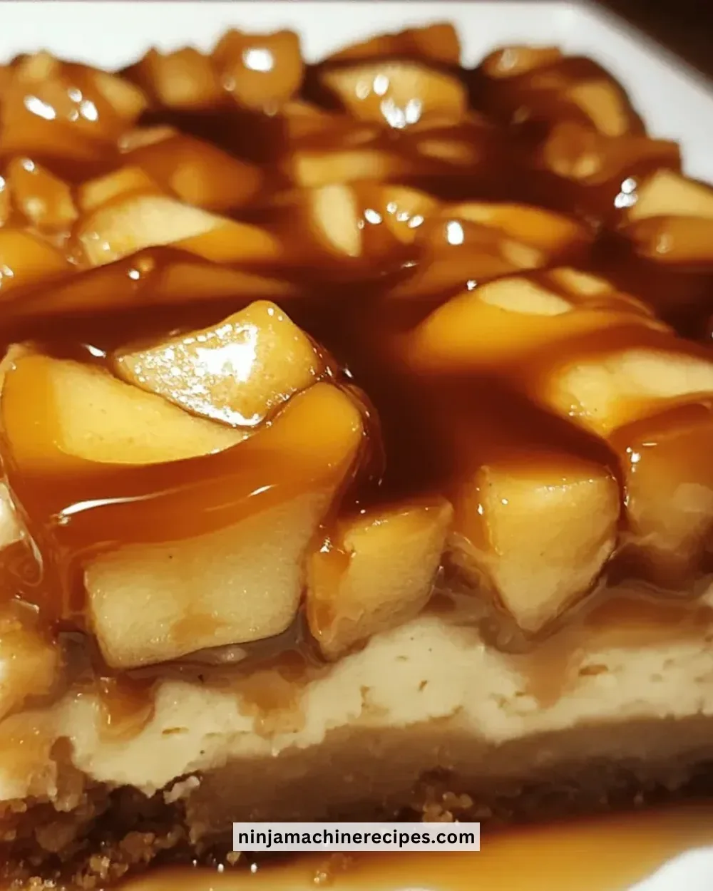 Delicious salted caramel apple cheesecake bars topped with caramel drizzle