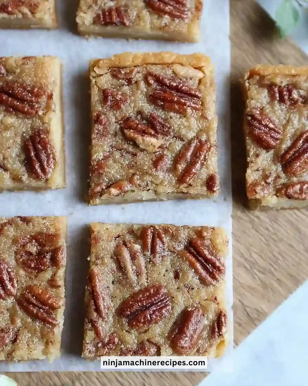 Delicious sheet pan pecan pie bars topped with caramel glaze.