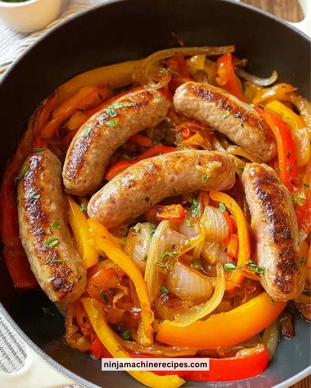 Italian sausage served with sautéed peppers and onions on a plate.