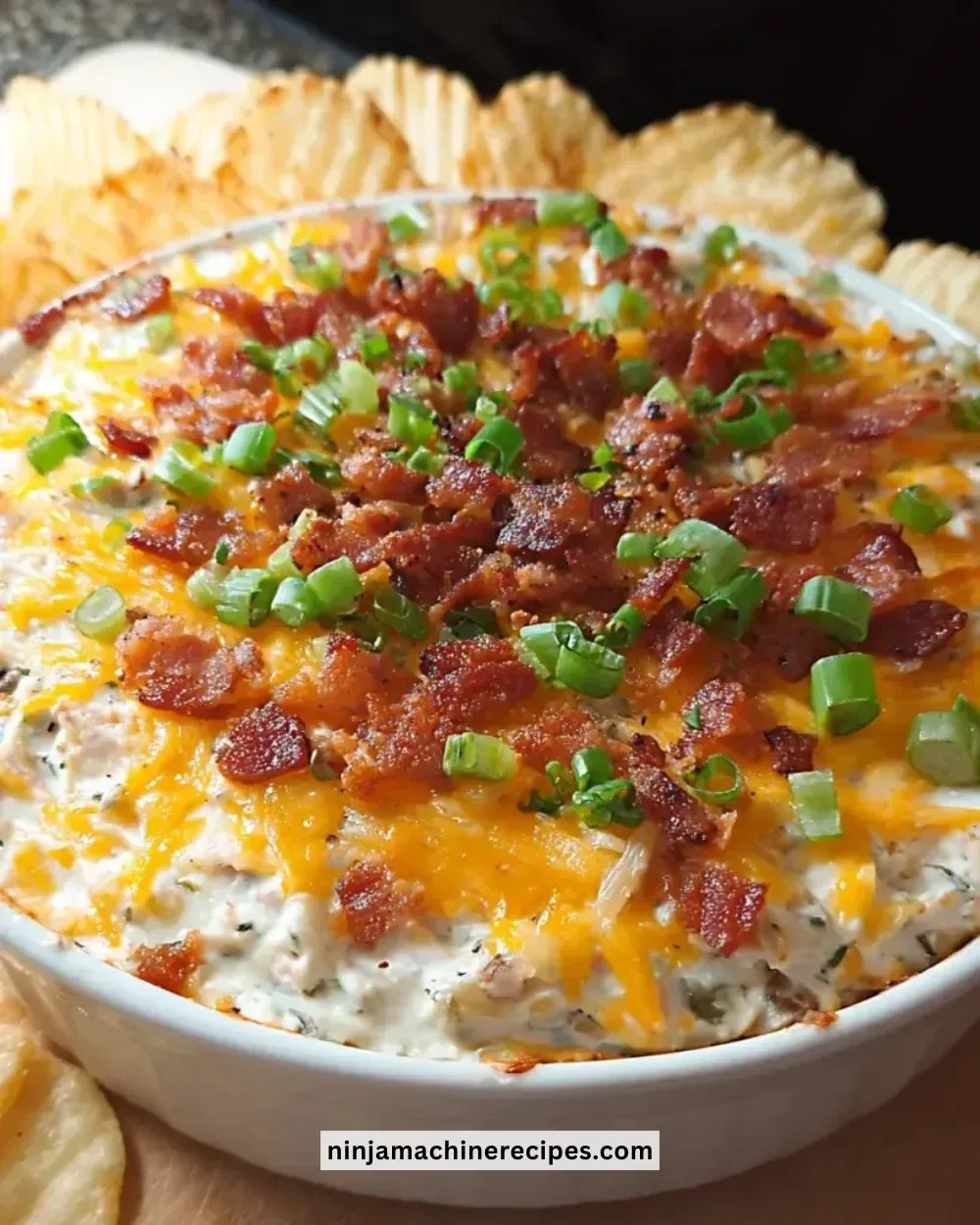 Creamy Loaded Baked Potato Dip served with crispy chips
