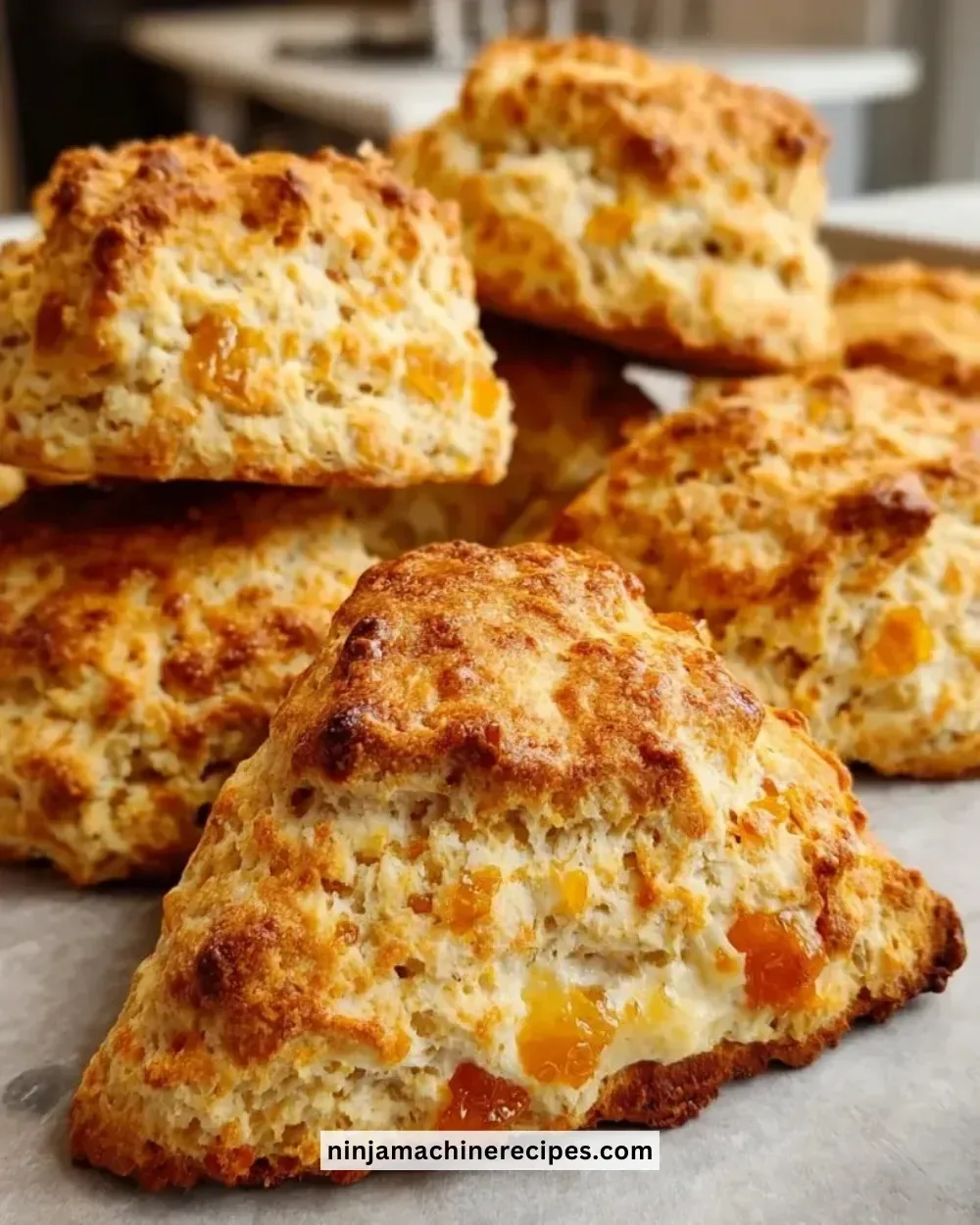 Freshly baked orange chai scones on a rustic wooden table