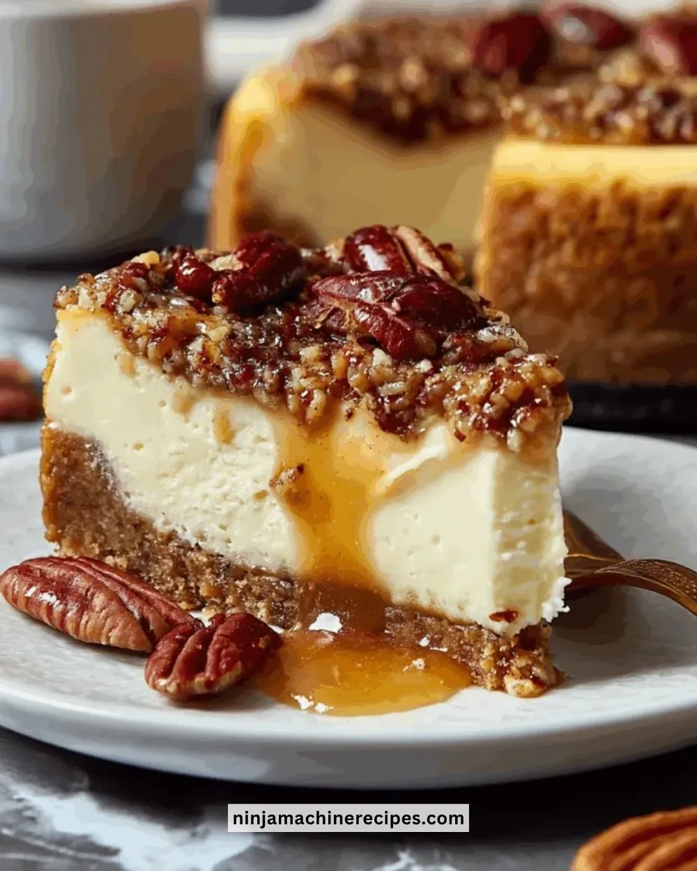A slice of delicious pecan pie cheesecake topped with caramel and pecans.