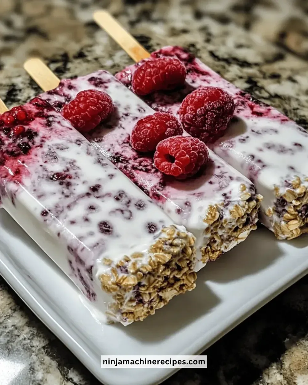 Refreshing mixed berry Greek yogurt pops on a wooden plate.