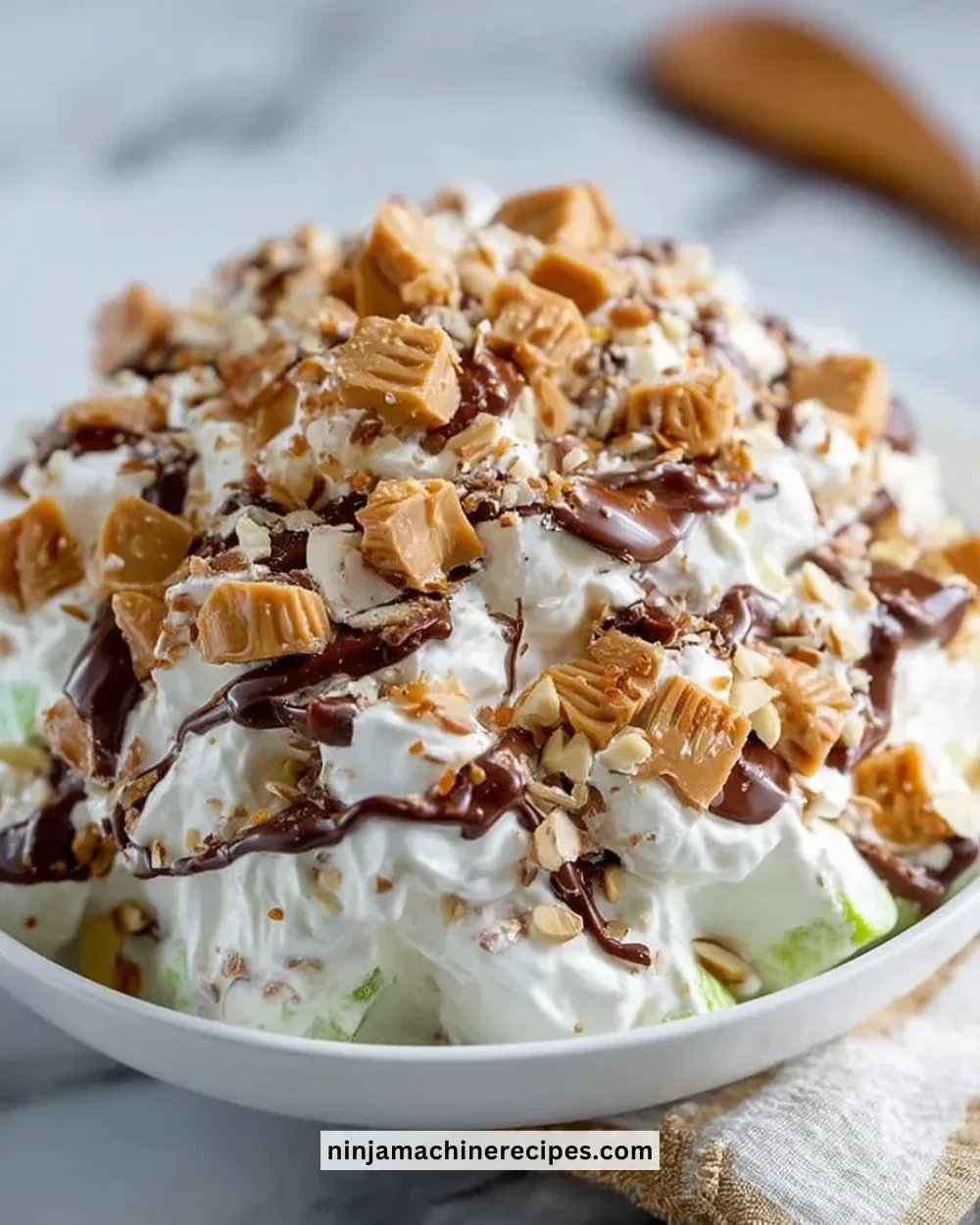 Delicious Snickers Salad made with apples, caramel, and Snickers bars.