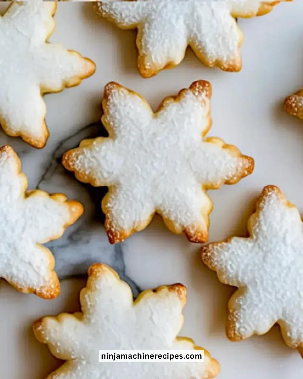 Snowflake sugar cookies with buttercream filling, decorated for winter