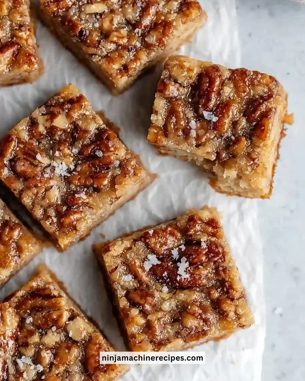 Delicious Paleo Pecan Pie Bars topped with pecans and a rich, grain-free crust.