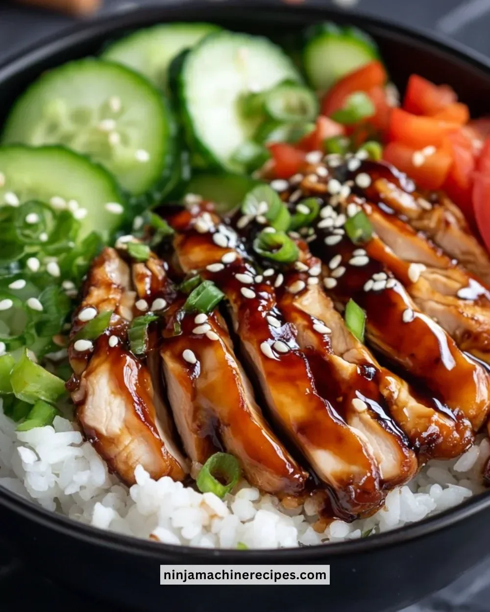Teriyaki Chicken Rice Bowl garnished with fresh vegetables and sauce