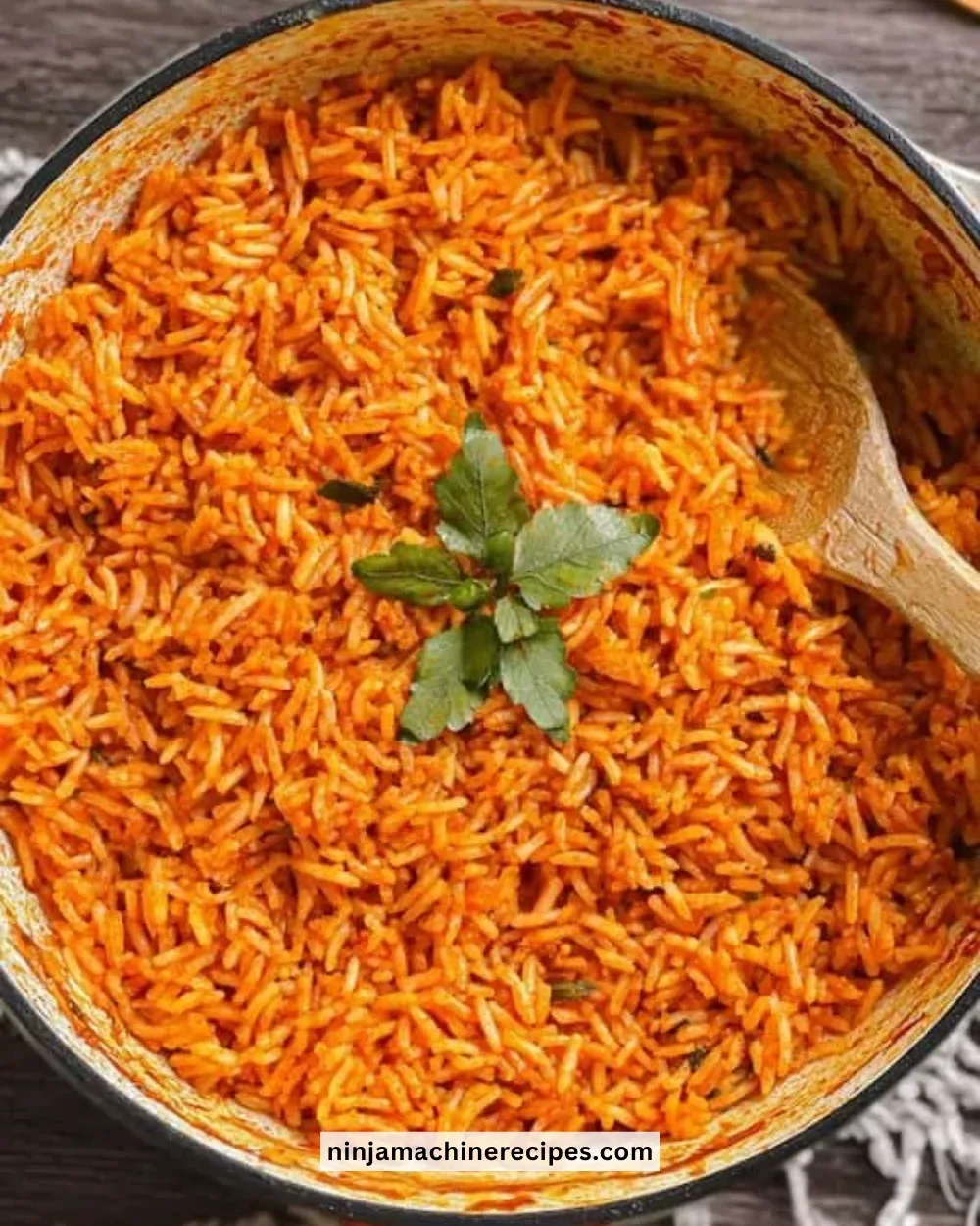 Delicious jollof rice dish garnished with herbs and spices on a table