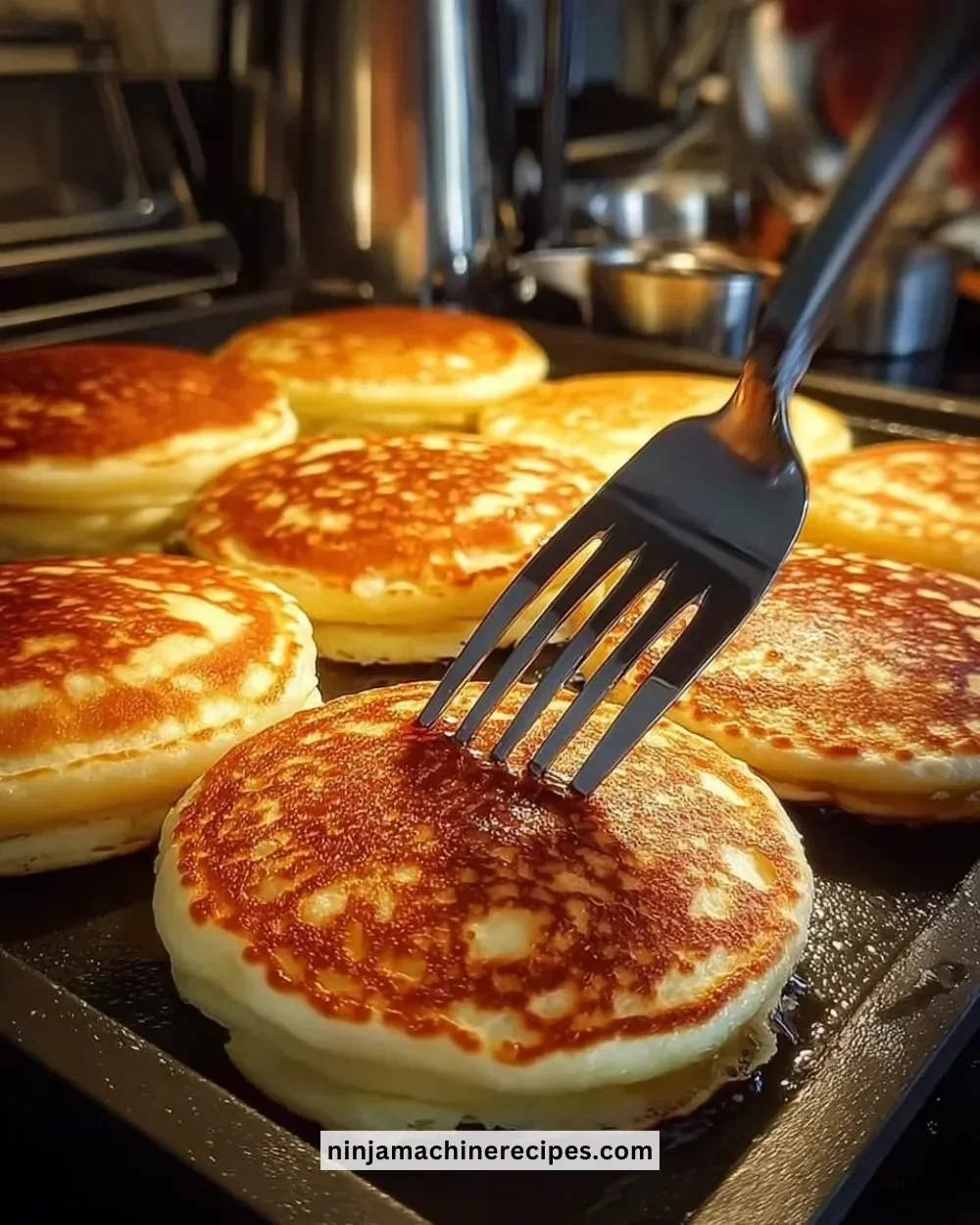 Stack of fluffy blueberry pancakes topped with fresh blueberries and syrup.