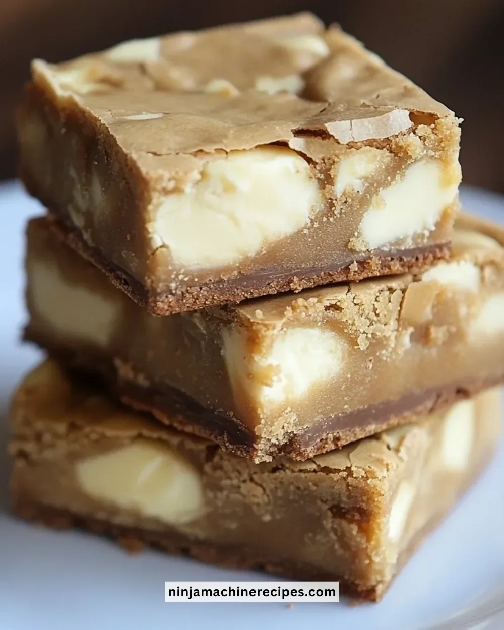 Delicious homemade white chocolate brownies on a white plate