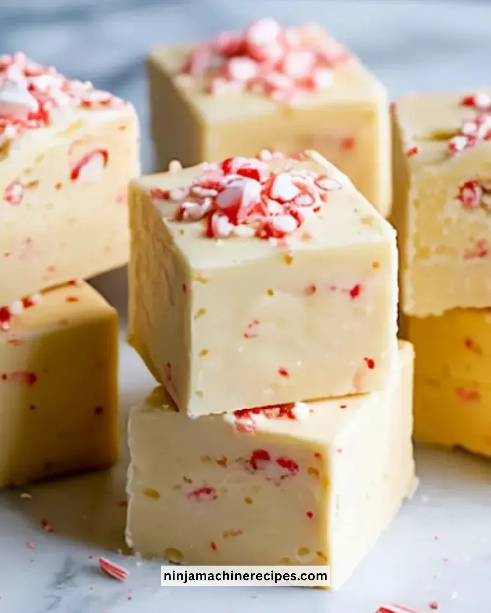 Delicious white chocolate peppermint fudge squares on a festive plate.