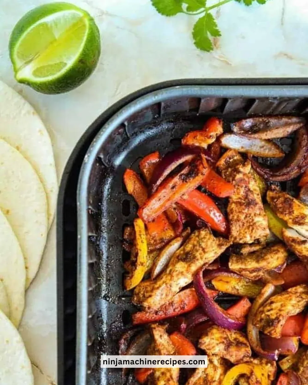 Air Fryer Chicken Fajitas served with peppers and onions on a plate
