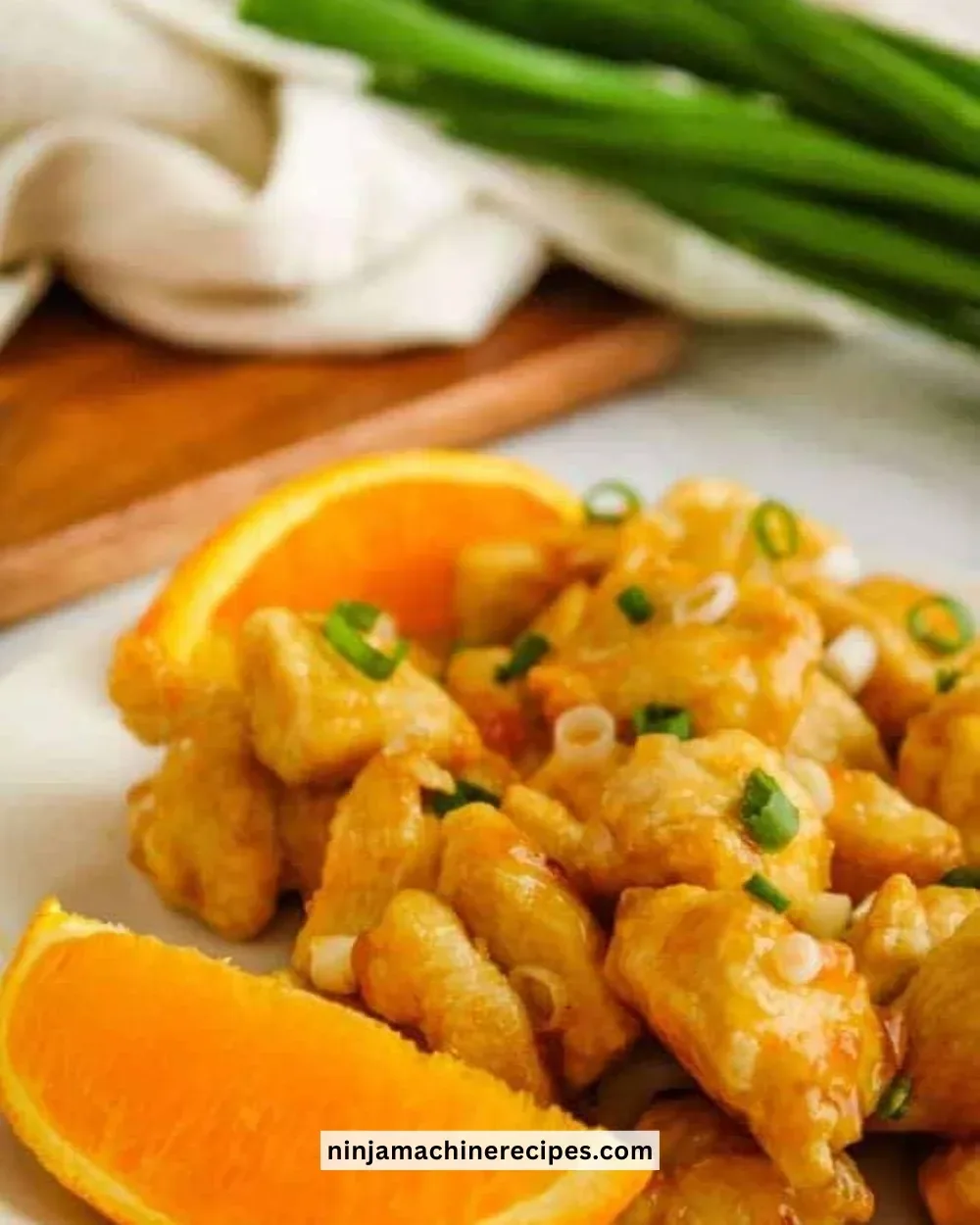 Delicious Air Fryer Orange Chicken served with vegetables on a plate