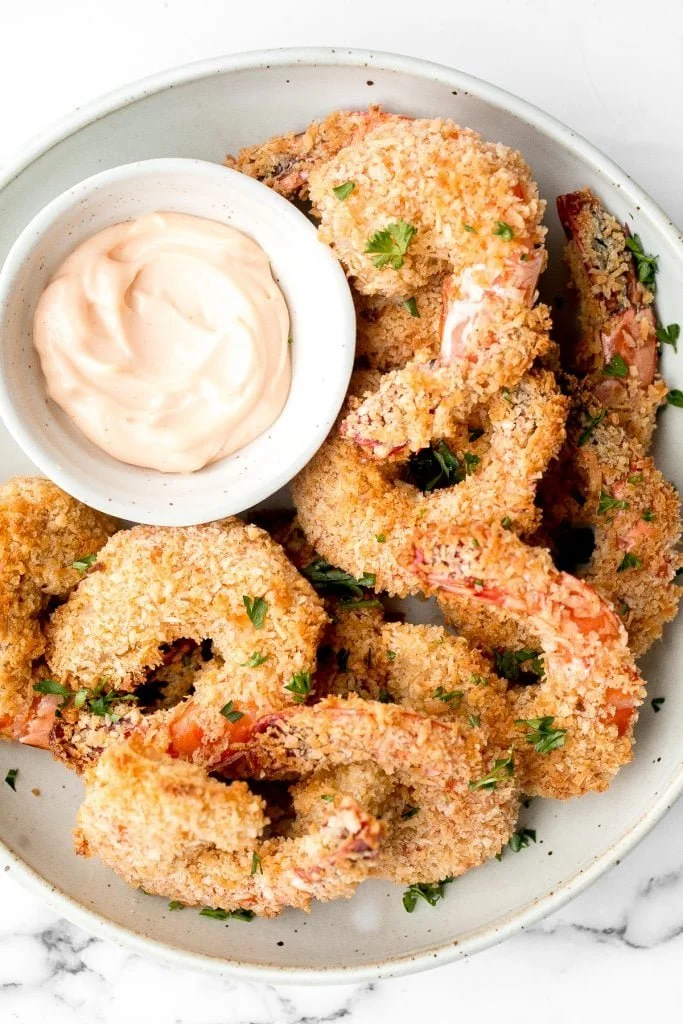 Plate of baked coconut shrimp with dipping sauce