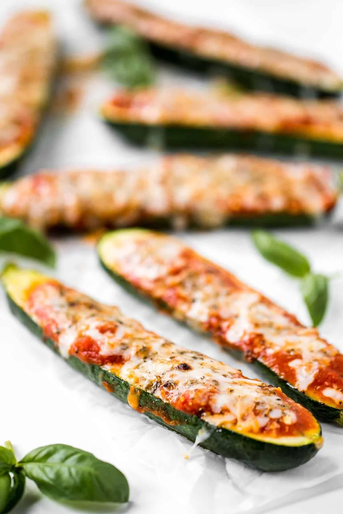 Baked zucchini boats topped with marinara sauce and melted cheese
