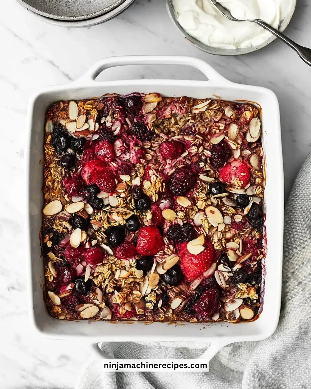 Delicious berry baked oatmeal topped with fresh fruits and nuts