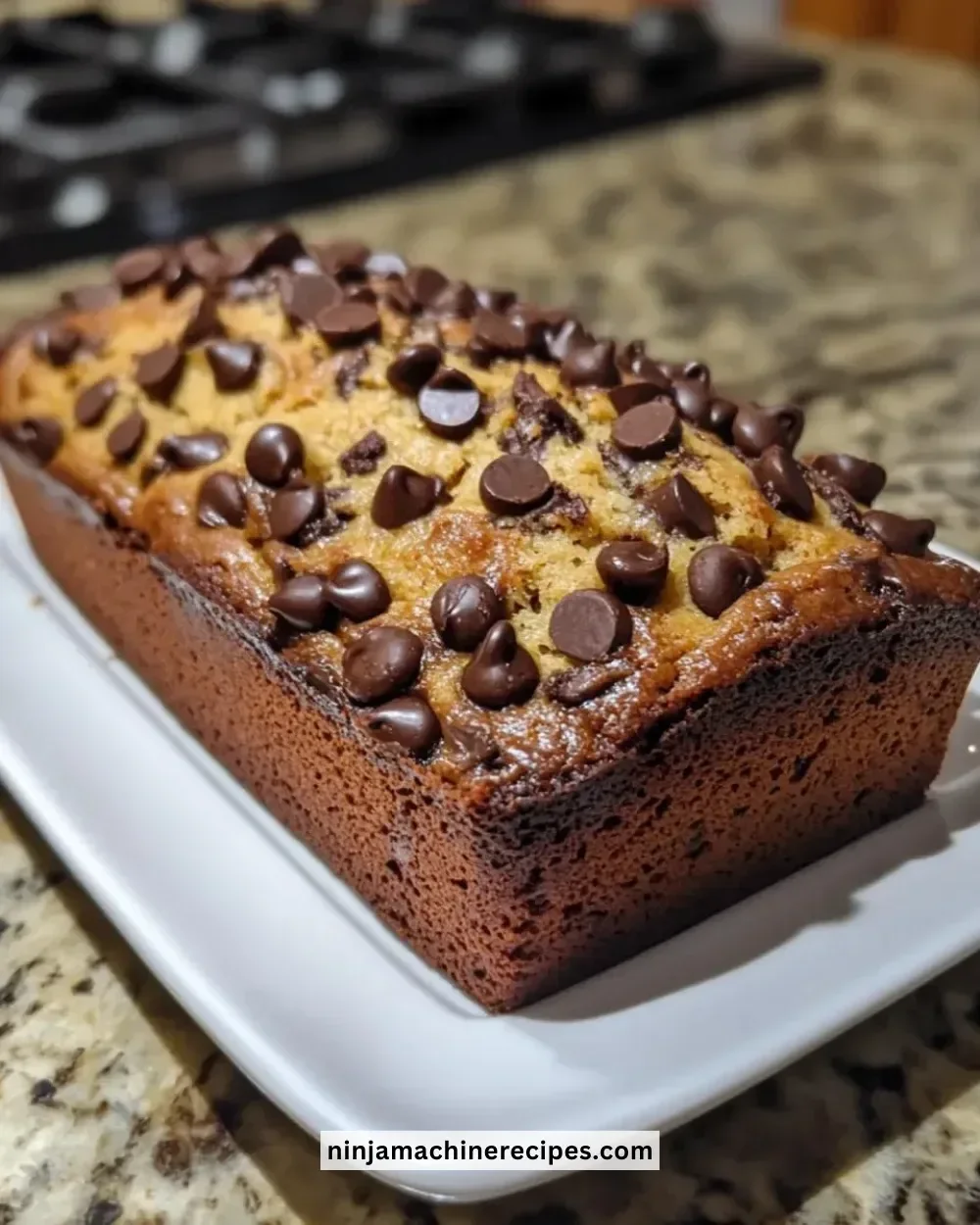 Slice of best ever chocolate chip banana bread with chocolate chips and bananas