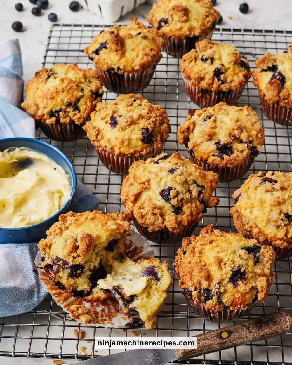 Freshly baked blueberry muffins on a cooling rack