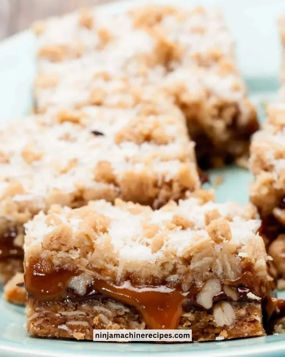 Delicious homemade Carmelita Bars topped with chocolate and caramel drizzle.