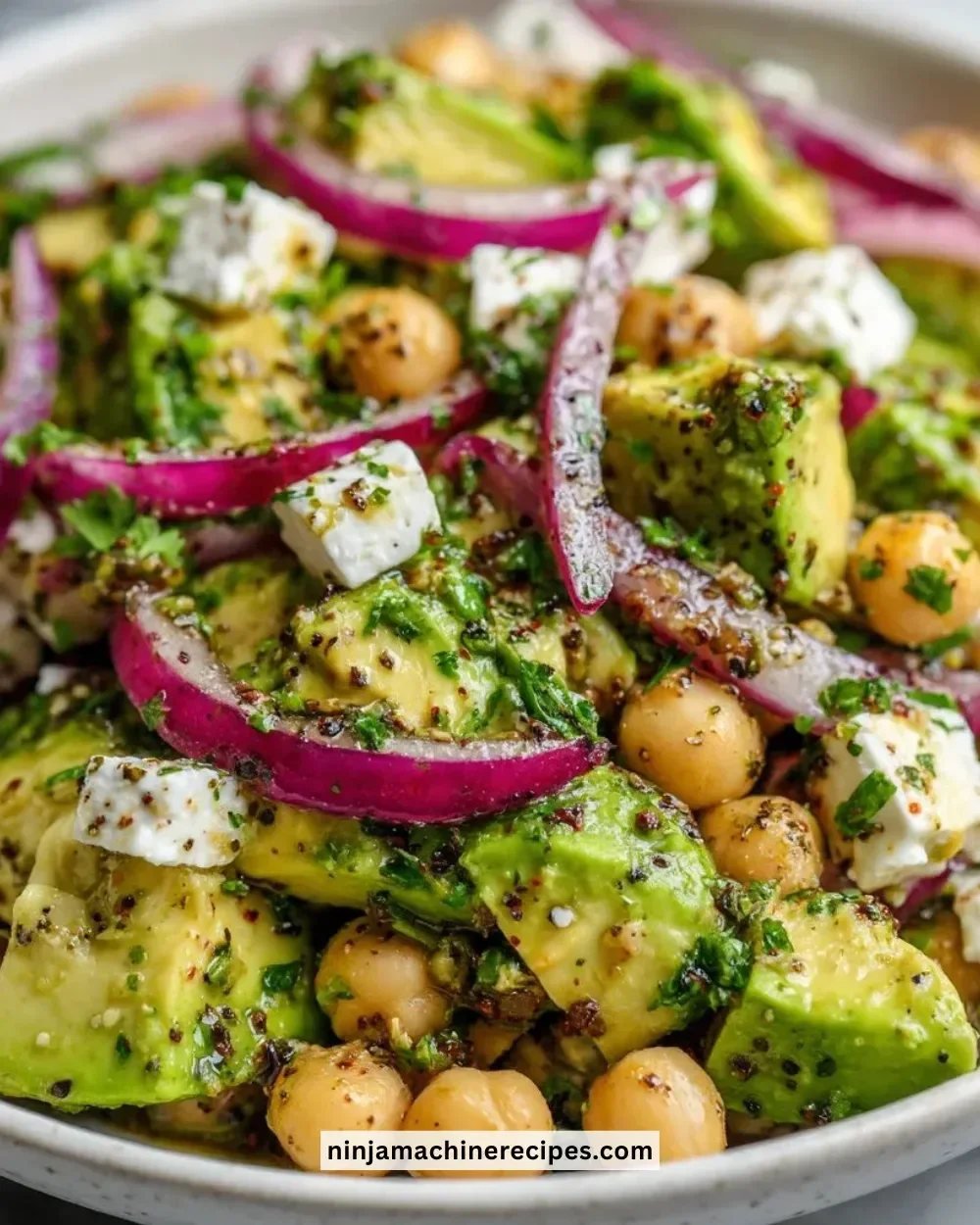 Chickpea feta avocado salad in a vibrant bowl with fresh ingredients