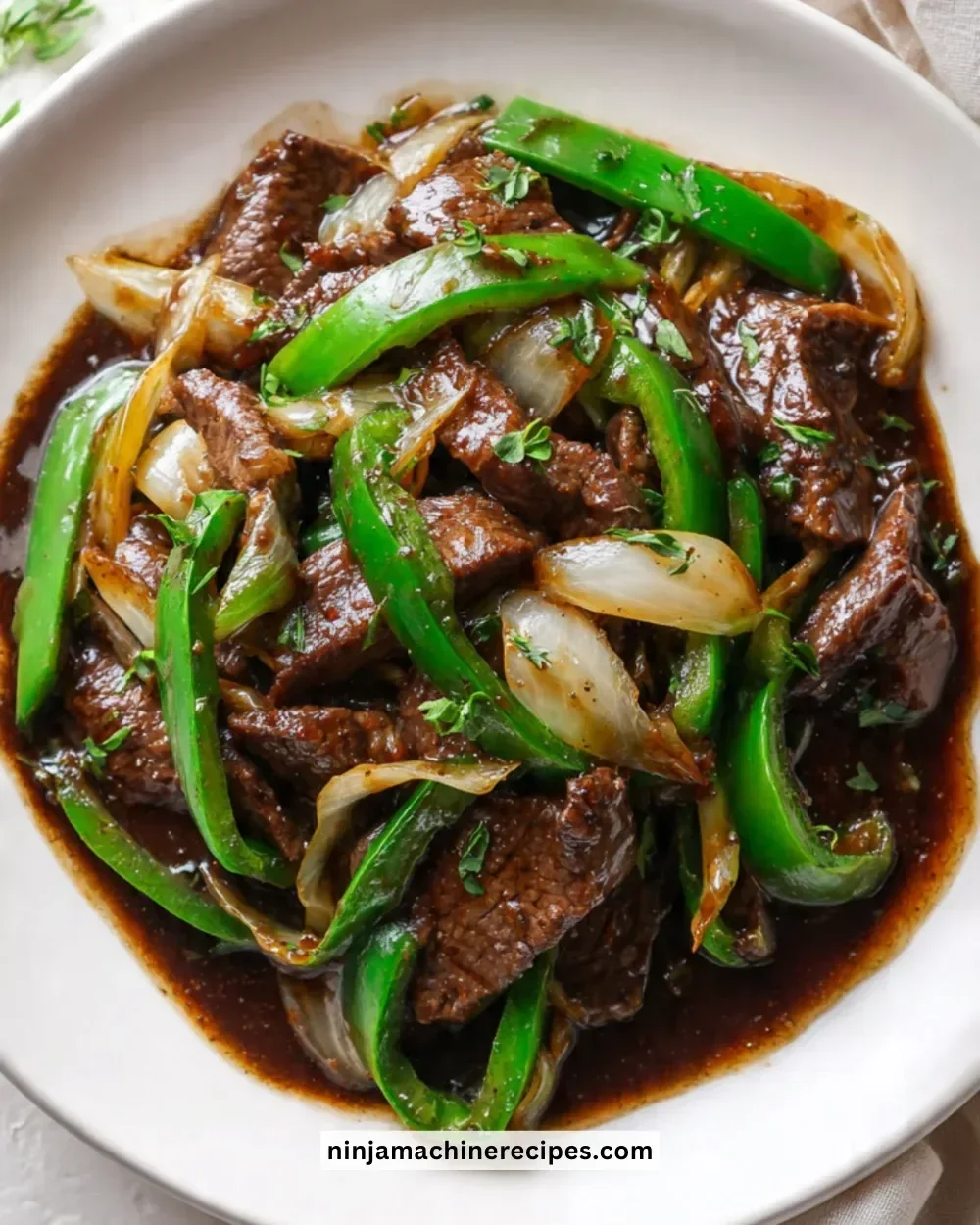 Chinese pepper steak with onions served in a bowl