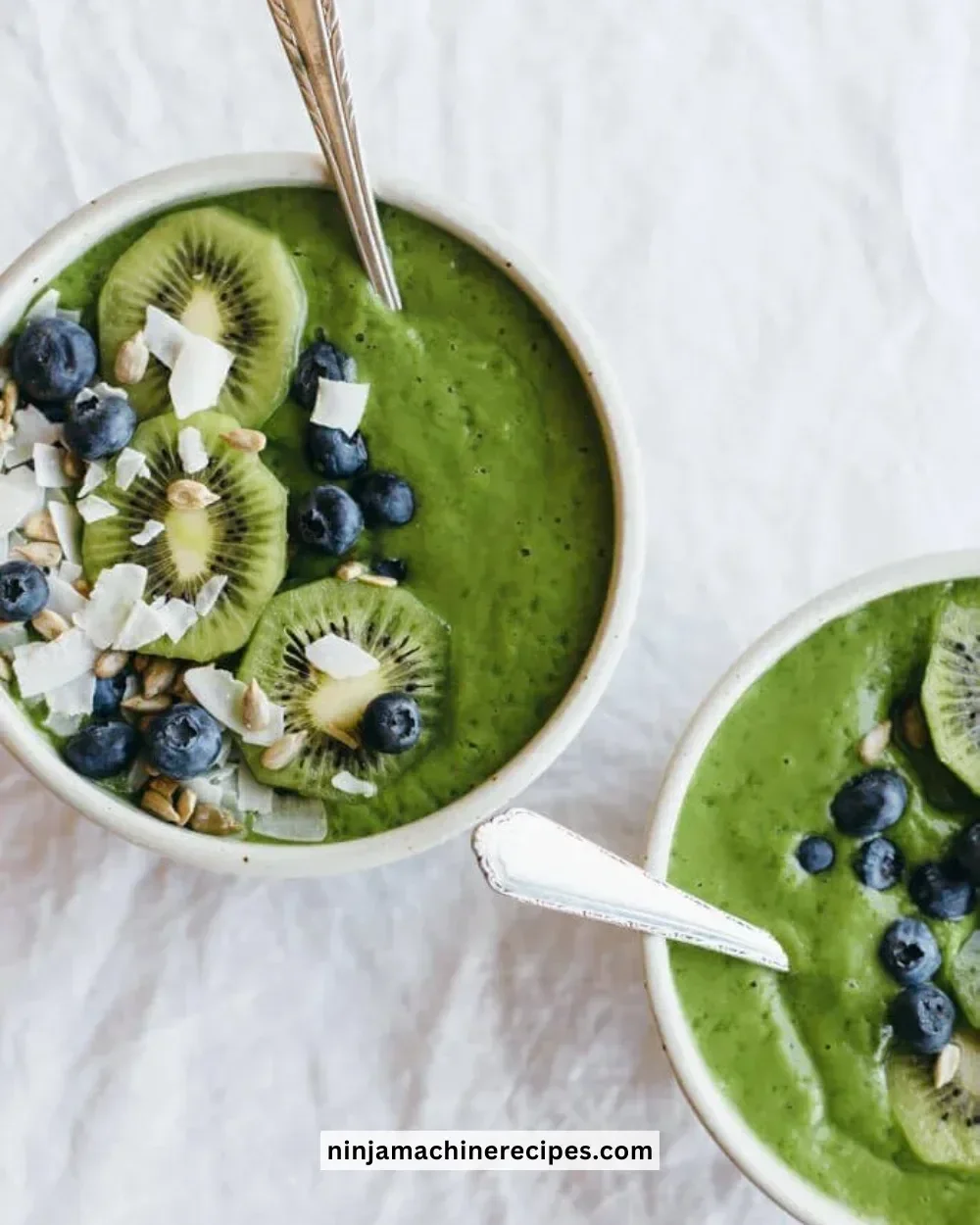 Delicious Clean Green Smoothie Bowl topped with fresh fruits and seeds